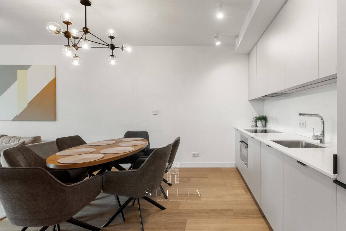 Nowoczesny, jasny salon z kuchnią i balkonem w apartamencie na wynajem.